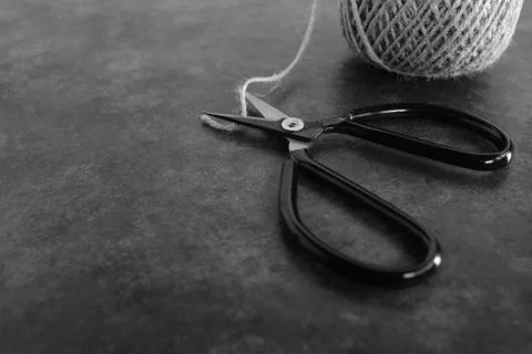 Old-fashioned scissors cutting piece of garden twine Stock Photos