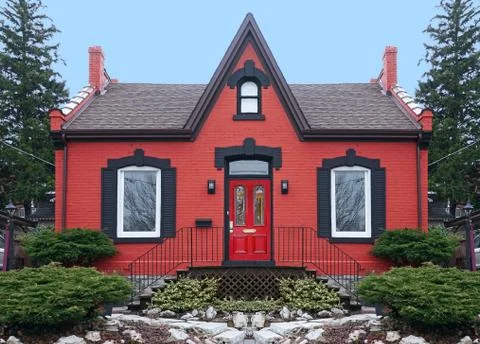 Old fashioned small red brick house with gable Stock Photos