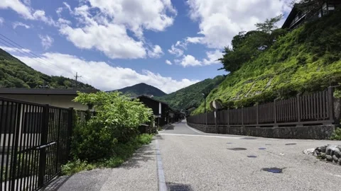 An old-fashioned small village under blue sky and white clouds Stock Footage 336519763