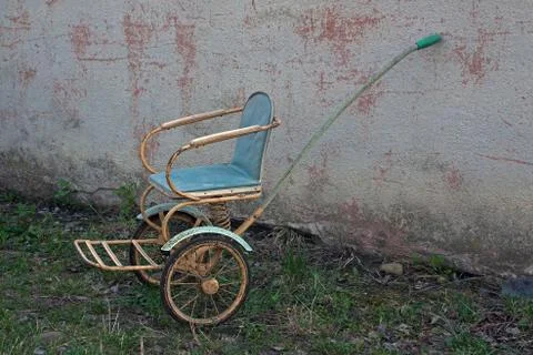 Old-fashioned soviet stroller with two wheels and one handle Stock Photos