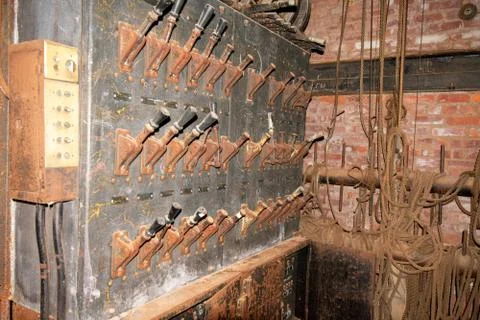 An Old Fashioned Switch Board Full of Rusty Levers With Black Handles in an A Stock Photos