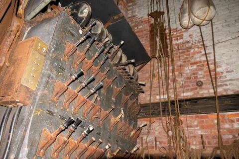 An Old Fashioned Switch Board Full of Rusty Levers With Black Handles in an A Stock Photos