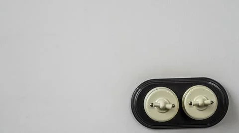 A old-fashioned switch wires is installed on a empty concrete wall. Electric Stock Photos