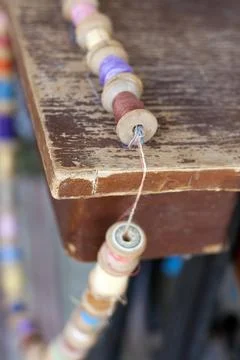 Old fashioned threads shpools on a string romantic order on obsolete wooden Stock Photos