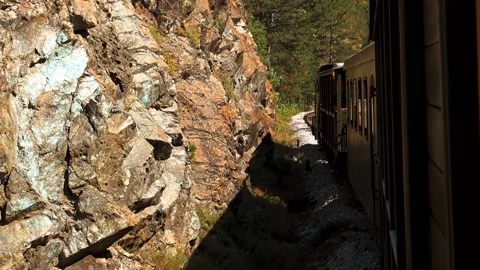Old fashioned train passing trough rocky landscape. Видео 162630465