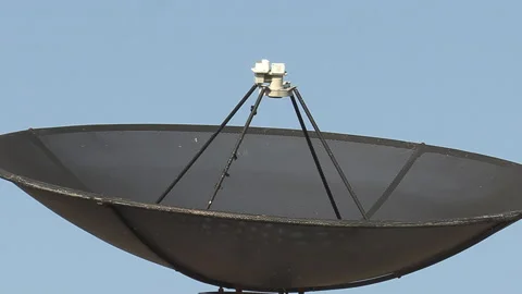 Old fashioned TV satellite dish on house roof for television signals reception Stockbeeldmateriaal 149858093