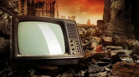 Old fashioned tv set laying in wasteland ruins. Stock Photos