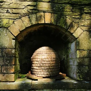 An old fashioned type of beehive called a skep. Stock Photos