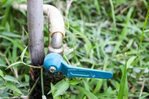 Old faucet in a grass Stock Photos