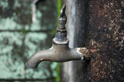 Old faucet on rustic wall Stock Photos