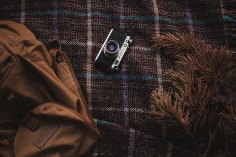 An old Fed camera on a bedspread in a cage. Vintage backpack Stock Photos
