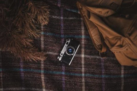An old Fed camera on a bedspread in a cage. Vintage backpack Stock Photos