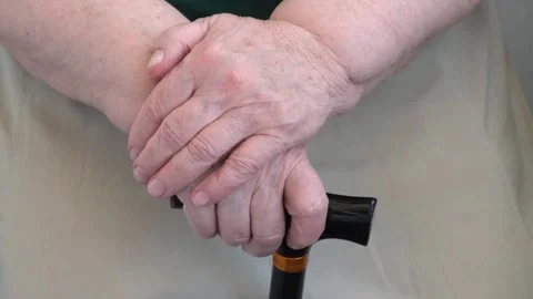 Old female hands on walking cane closeup. Senior woman resting Stock Footage 344837368