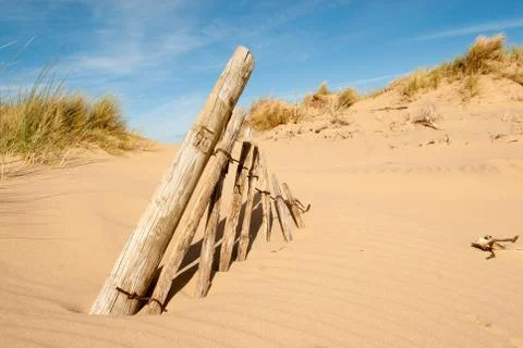 Old Fence posts in sand Stock Photos