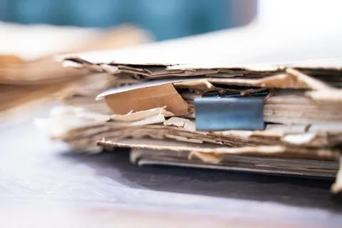 Old file folder with stacks of old and torn papers Stock Photos