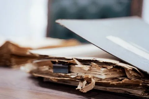 Old file folder with stacks of old and torn papers Stock Photos