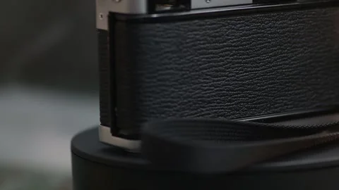 Old film camera close-up with yellow light quickly spins around its axis Stock Footage 281098089