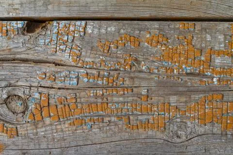 Old filthy pine board with cracks and knot, covered orange paint Stock Photos