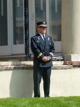 Old fire chaplain in uniform stands with hands folded on Memorial Day Stock Photos
