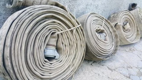 Old fire hoses close-up, including aluminum piping Stock Photos