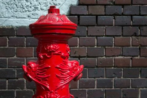 Old fire hydrant against the brick wall Stock Photos