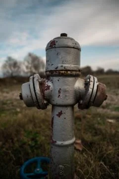 Old fire hydrant on a field of grass filled with rust Stock Photos