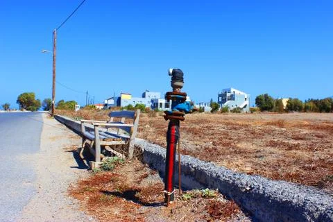 An old Fire Hydrant stands next to a bench in the middle of a street on the c Stock Photos