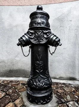Old fire hydrant, water column on the street in Sion Stock Photos