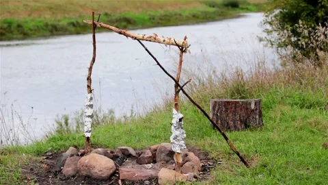 The old fire pit on the river Bank. The light breeze. Video stock 71588392