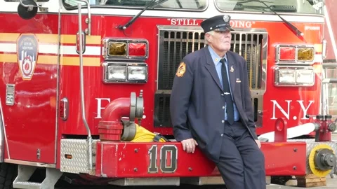 Old firefighter and fire truck, Patriot Day. FDNY firemen by firetruck. New Stock Footage 341660761