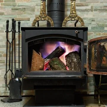 Old fireplace with a burning firewoods Stock Photos