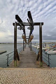 Old fish unloading gear-Rio Arade estuary-Calçada Portuguesa paving. Portimao-PT Stock Photos