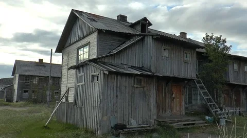 The old fishing village. Car and dilapidated old wooden houses. Stock Footage