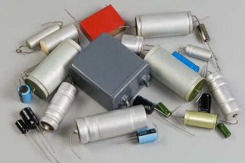 Old fixed common and electrolytic capacitors on a gray surface 写真素材