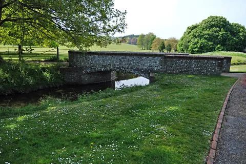 Old flint bridge over the river Stock Photos