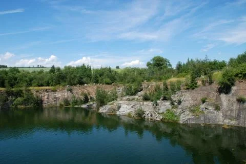 Old flooded quarry Stock Photos