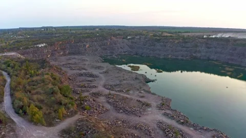 Old flooded stone quarry, site of natural granite stone mining Stock Footage 147117793