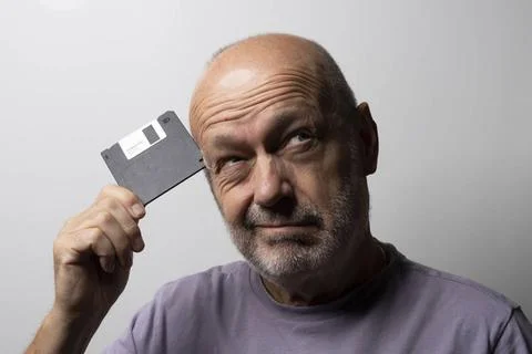 Old floppy disk for data storage a man with an old floppy disk in his hand... Stock Photos