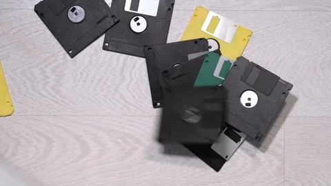 Old floppy disks fall on the floor Stock Footage 121534857