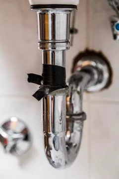 Old flowing drainpipe in kitchen or bathroom Stock Photos