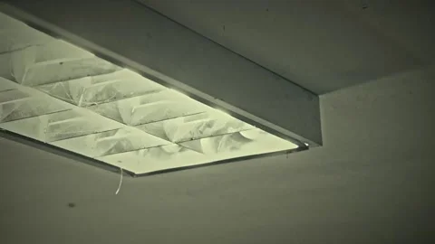 Old Fluorescent Lamp Flickering On and Off with Buzzing Sound in a Dark Gym Video stock 329764262