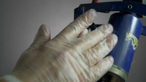 With an old foot pump, dusting hands in rubber gloves Stock Footage 153550639