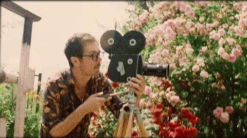 Old footage of director cameraman using film video camera Stock Footage 110923956