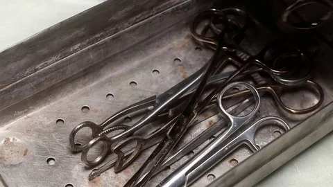 Old forceps and medical scissors in steel tray. Stock Footage 72742874