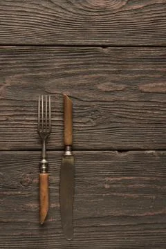 Old fork and knife on the table Stock Photos