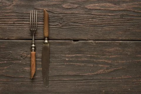 Old fork and knife on the table Stock Photos