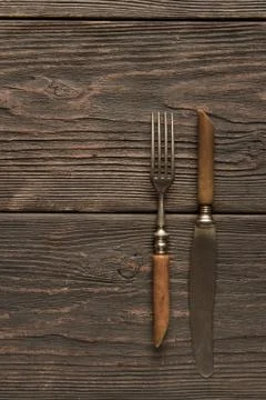 Old fork and knife on the table Stock Photos
