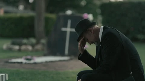 An old friend of the deceased grieving over his grave Stock Footage 262302811