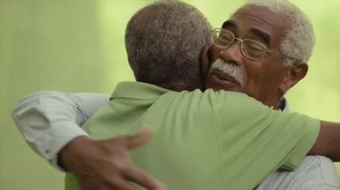 Old friends, two senior african american men meeting and hugging Stock Footage