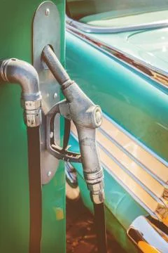 Old fuel pump in front of a classic car Stock Photos
